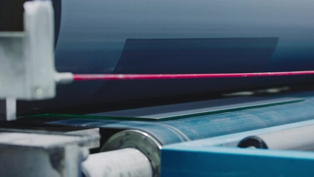 The glass goes into the machine on rollers and goes through the tempering process