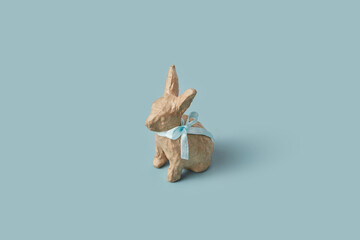 Handmade paper Easter bunny with blue bow.