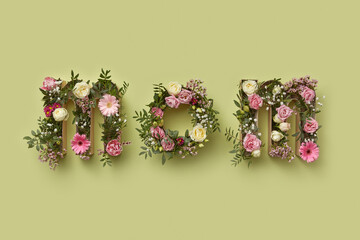 Word MOM made of flowers inside craft boxes.