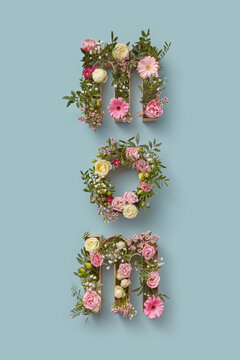Spring flowers in boxes in form of MOM word.
