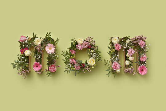 Word MOM made of flowers inside craft boxes.