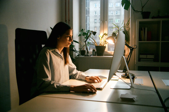 Film photo businesswoman in her office at night working late