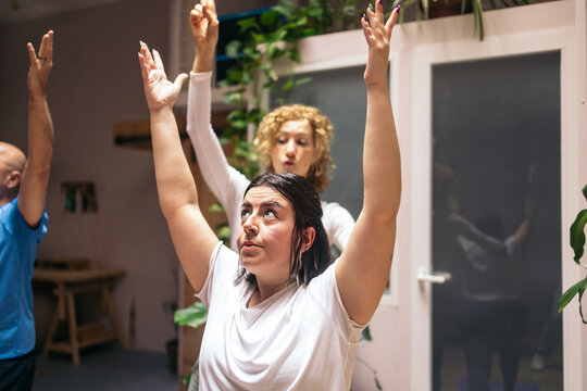 Female Yoga Instructor Helping Student