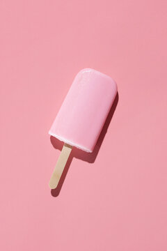 Strawberry popsicle on pink background
