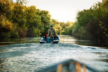Boat skipper and boat on Danube delta canal