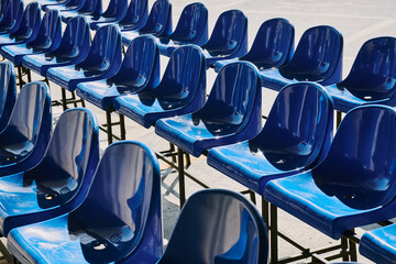 Rows of blue plastic chairs