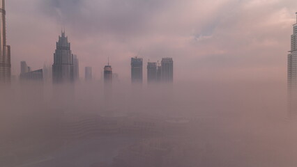 Aerial view morning fog covered Dubai International Financial Centre district timelapse