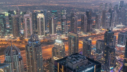 JLT and Dubai marina skyscrapers near Sheikh Zayed Road aerial day to night timelapse. Residential buildings