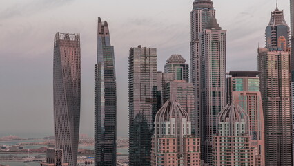 Skyscrapers of Dubai Marina near intersection on Sheikh Zayed Road with highest residential buildings night to day timelapse