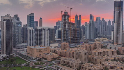 Fototapeta na wymiar Dubai's business bay towers at sunset aerial timelapse. Rooftop view of some skyscrapers