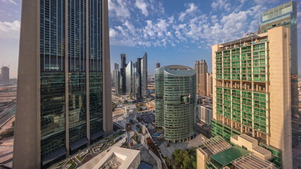 Dubai international financial center skyscrapers with promenade on a gate avenue aerial all day...
