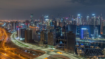 Fototapeta na wymiar Skyline with modern architecture of Dubai business bay towers all night timelapse. Aerial view
