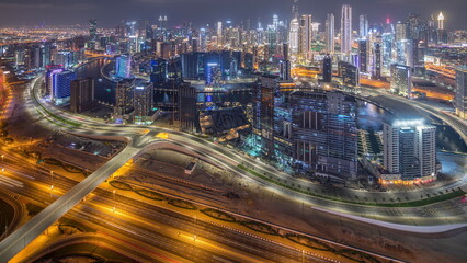Fototapeta na wymiar Panorama showing skyline of Dubai with business bay and downtown district night timelapse.
