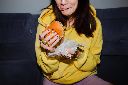 Holding burger in hand 