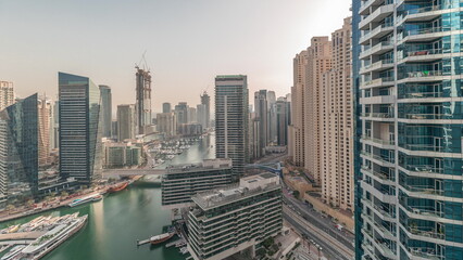 Fototapeta na wymiar Panorama showing overview to JBR and Dubai Marina skyline with modern high rise skyscrapers waterfront living apartments aerial timelapse