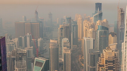 Skyline panoramic view of Dubai Marina showing an artificial canal surrounded by skyscrapers along shoreline timelapse. DUBAI, UAE