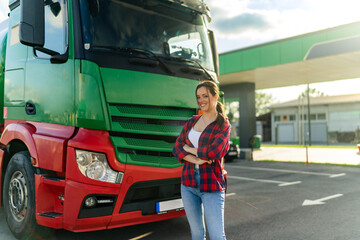 A young woman poses in front of her first cargo truck before embarking on a cross-country tour