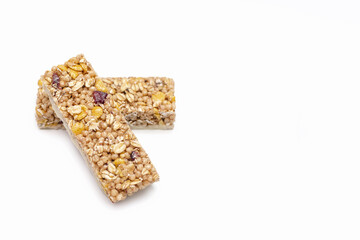 Two muesli bars on a white isolated background. Healthy sweet dessert snack. Cereal muesli with nuts, oatmeal and berries on a white background. Free space for text