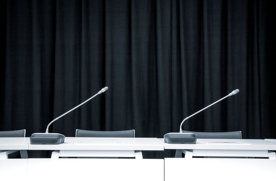 Minimalist conference room interior with two microphones on the 