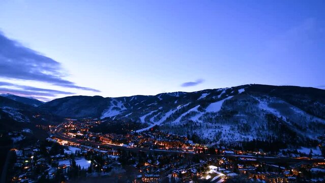 Timelapse of the milky way disappearing into sunrise over Vail Ski Resort and town of Vail in Colorado.