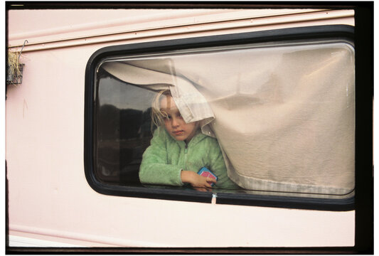 Girl peeking through camper window