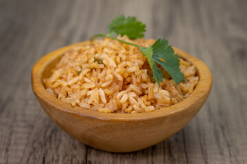Side order of Mexican rice with cilantro on top and servved in a decorative bowl
