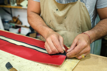 Latin artisan making a leather bag