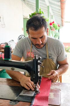 Latin designer at work on a sewing machine