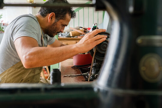 Latino tailor using a sewing machine