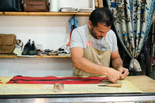 Latino dressmaker working in the workshop