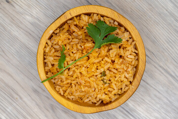 Overhead view of side order of Mexican rice with cilantro on top and servved in a decorative bowl