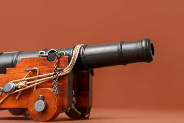 Toy model of cannon on brown background