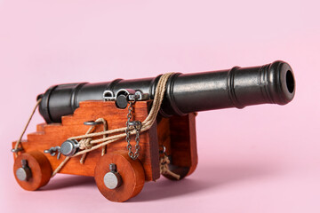 Toy model of cannon on pink background
