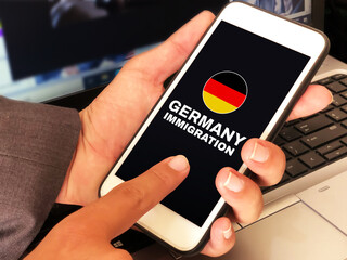 Immigration to Germany concept background with a person applying for German immigration on mobile