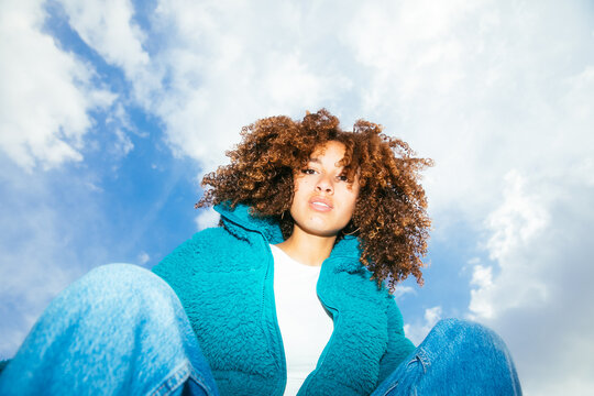 Sitting woman with curly hair 