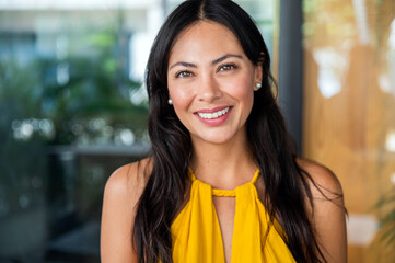 Smiling asian woman portrait wear yellow dress looking at camera