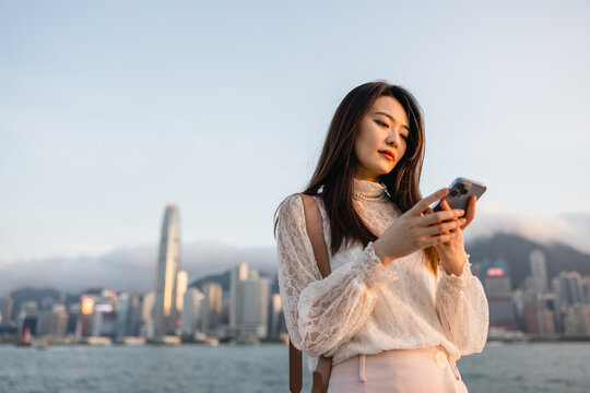 Portrait of a young business Asian Woman using a phone