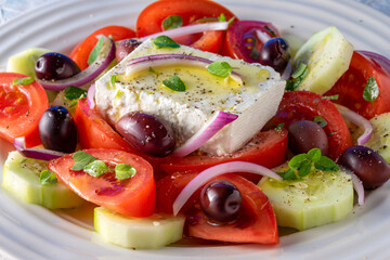 Greek salad on white serving dish.