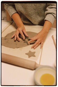 Woman's hands making pottery Christmas adornments