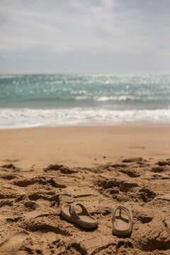 flip flops in the sand of a beach