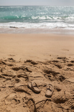 flip flops in the sand of a beach