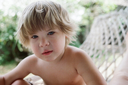 Portrait of a toddler sitting in hammock