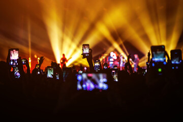 Fototapeta na wymiar Capturing memories, Smartphones at Live concert Show.