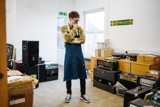 Wistful man standing in workshop