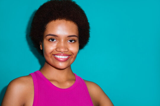 Young woman with healthy skin poses in front of the camera