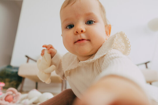 Baby trying to reach camera