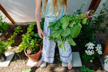 Young girl in a homestead garden