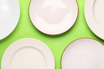 Composition with clean plates on green background