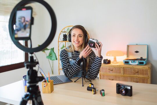 Woman looking at a smartphone filming