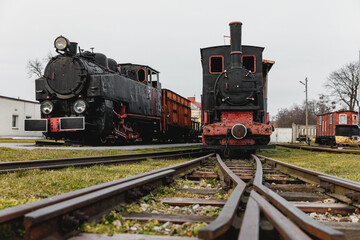 Fototapeta na wymiar Classic steam engine at an open-air railway yard.